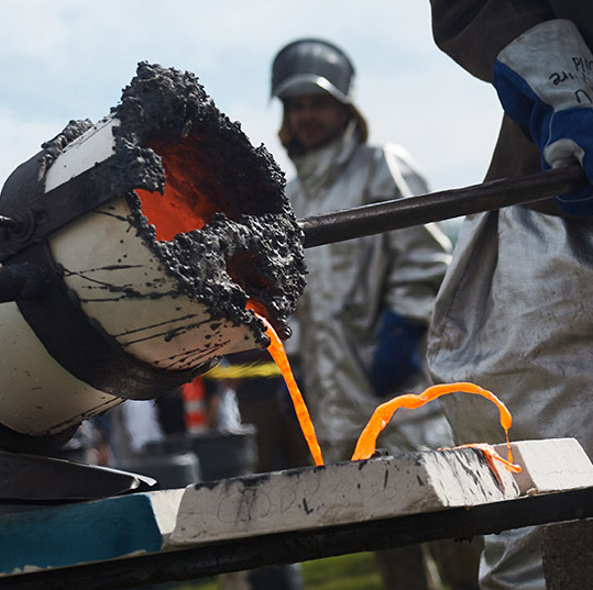 Student working on an iron pour